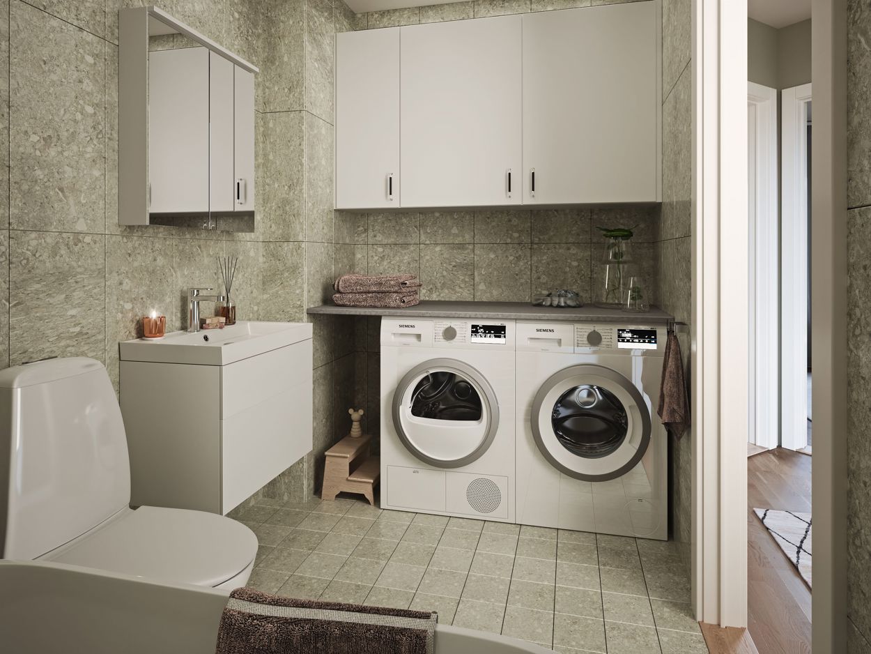Badrum på övre plan med tvättmaskin och torktumlare (bilden är en rendering och kan innehålla tillva